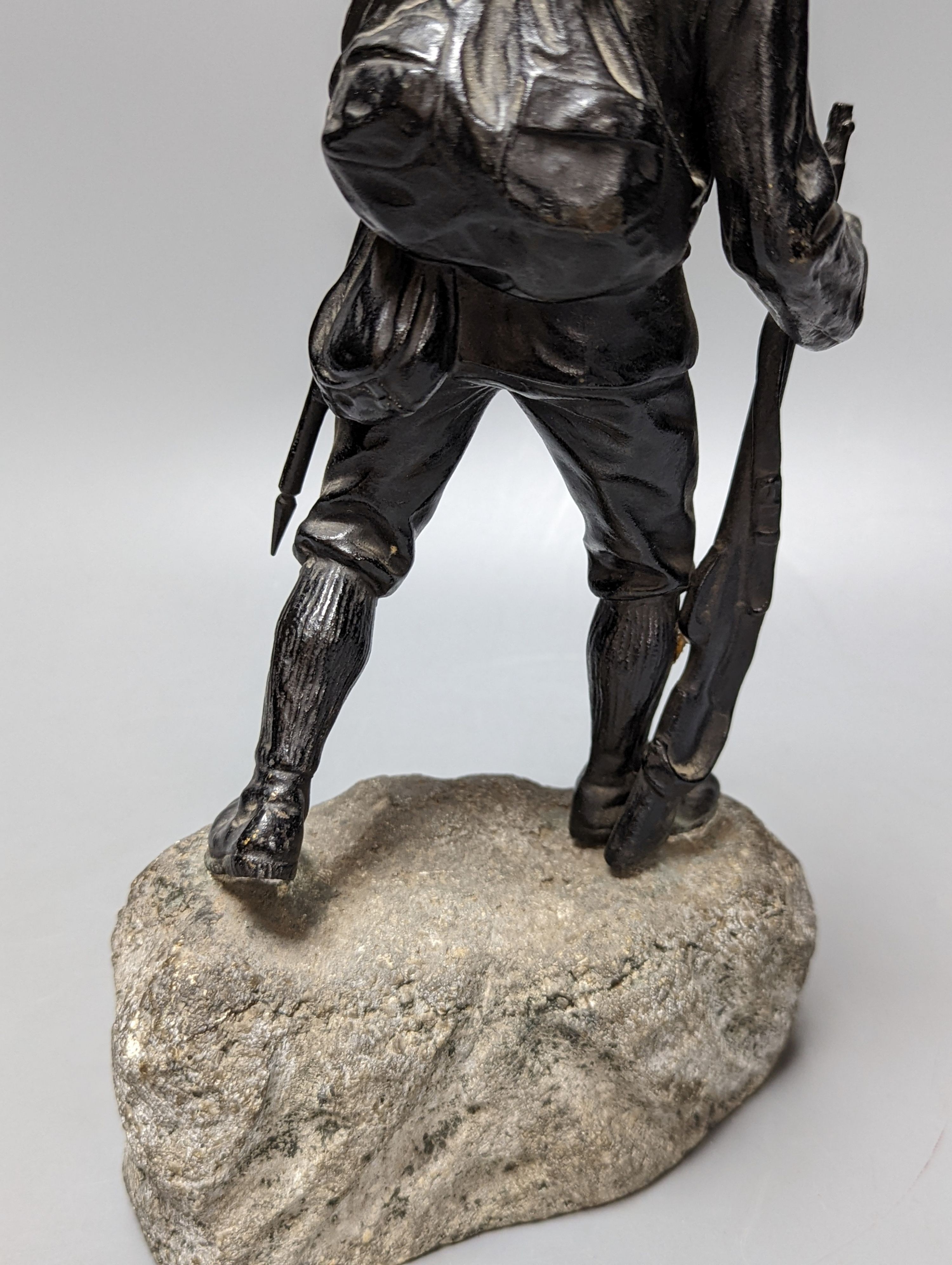 A WW1 period bronze figure of an Austrian soldier, 30 cms high including stone base.